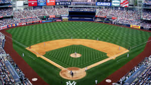 Spectacular Baseball Stadium Lit Up In Nighttime Wallpaper