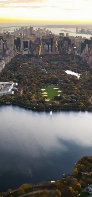 Spectacular Landscape Featuring Rolling Meadows And A Beautiful Orange Sky Wallpaper