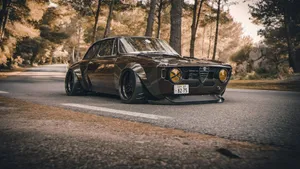 Speed Through The City In An Iconic 1965 Alfa Romeo Wallpaper