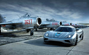 Speed Through The Skies And Roads With Jet And Car Wallpaper