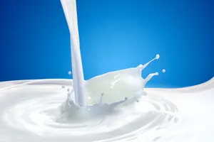 Splashes And Ripples From Pouring Milk Wallpaper