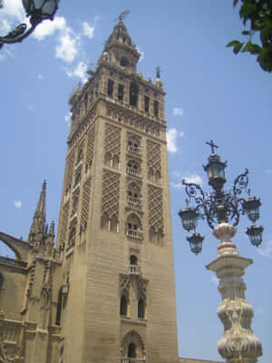 Splendid View Of The Giralda Tower Of Seville Cathedral Wallpaper