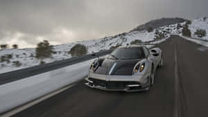 Sports_ Car_ Speeding_in_ Snowy_ Mountains.jpg Wallpaper