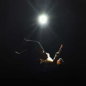 Spotlighted_ Performer_on_ Stage Wallpaper