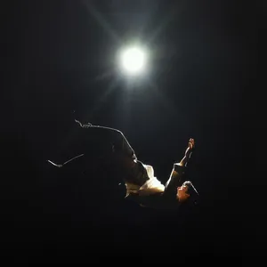 Spotlighted_ Performer_on_ Stage Wallpaper