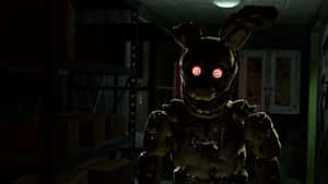 Springtrap In The Shadows - A Menacing Springtrap Character Lurking In The Darkness Wallpaper