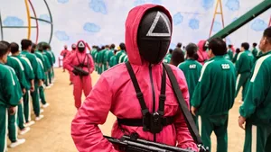 Squid Game Red Guard With Gun Wallpaper