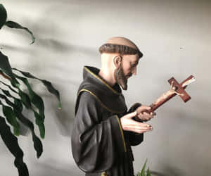 St Francis Statue Holding Cross Wallpaper
