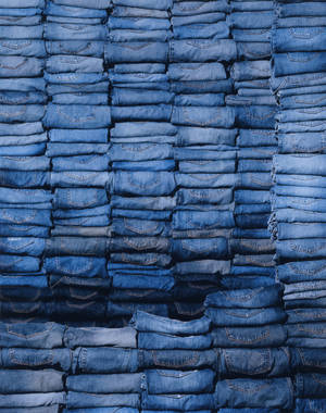 Stacks Of Denim Folded Jeans Wallpaper