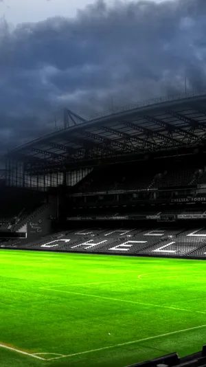 Stadium Silhouette Under Stormy Skies Wallpaper