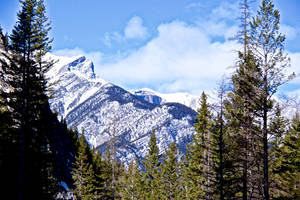 Stand Atop A Spectacular Mountain And Take In A Breathtaking View Of The Snow-covered Scenery. Wallpaper