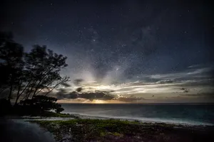 Starry_ Night_ Over_ Coastal_ Shoreline Wallpaper