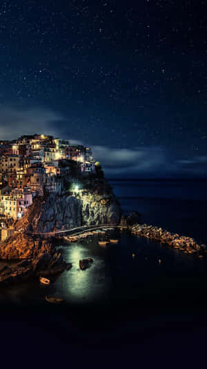 Starry_ Night_ Over_ Coastal_ Village Wallpaper