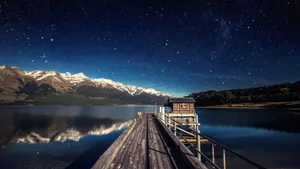 Starry Night Over Mountain Lake Pier Wallpaper