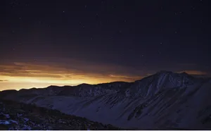 Starry_ Night_ Over_ Snowy_ Mountains.jpg Wallpaper