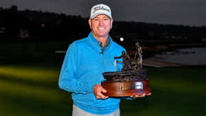 Steve Flesch Holding Sculpted Trophy Wallpaper