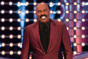 Steve Harvey In A Burgundy Suit Wallpaper