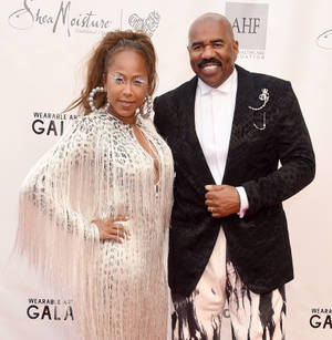 Steve Harvey Posing With His Wife Wallpaper