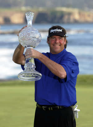 Steve Lowery Proudly Holding Up Trophy Wallpaper