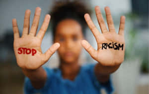 Stop Racism Written On Both Hands Wallpaper