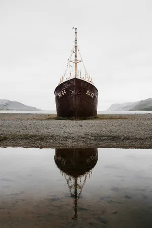 Stranded Boat And Its Reflection Wallpaper
