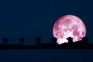 Strawberry Moon Over Silhouetted Structures Wallpaper