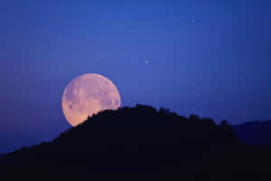 Strawberry Moon Rising Over Hills Wallpaper