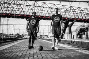 Street Soccer Playersat Train Station Wallpaper