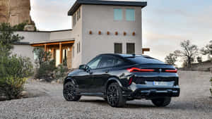 Striking Bmw X6 Displayed Against A Stunning Cityscape Wallpaper