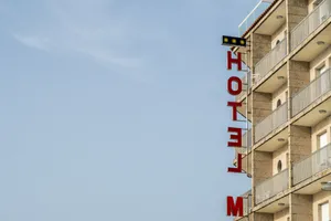 Striking Hotel Signage In The City Night Wallpaper