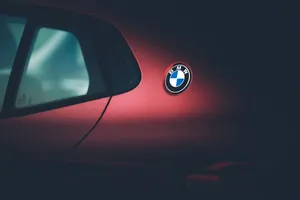 Striking Logo Of Bmw On A Dark Background Wallpaper