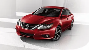 Striking Nissan Altima On The Road Wallpaper