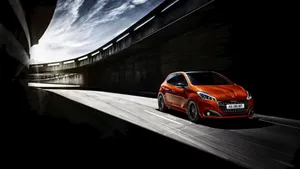 Striking Peugeot 208 On The Open Road Wallpaper
