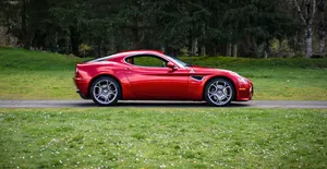 Striking Red Alfa Romeo 8c Competizione In Motion Wallpaper