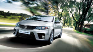 Striking Silver Kia Forte Parked On A Street Wallpaper