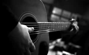 Strumming Guitar Musical Instrument Black And White Wallpaper