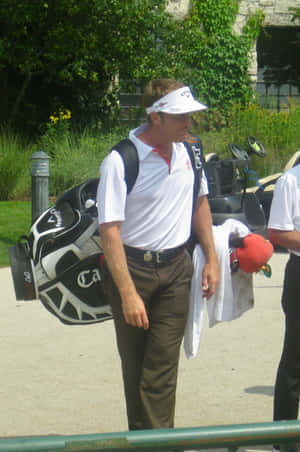 Stuart Appleby Carrying A Caddy Bag Wallpaper