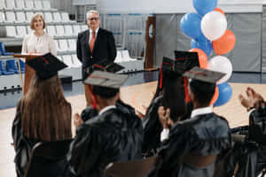 Students Celebrating A Successful Graduation Ceremony Wallpaper