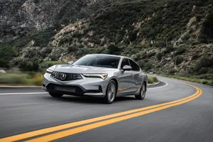 Stunning Acura Integra Sport Coupe On A Scenic Mountain Road Wallpaper