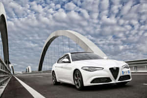 Stunning Alfa Romeo Giulia On A Picturesque Road Wallpaper