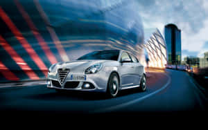 Stunning Alfa Romeo Giulietta On A Picturesque Countryside Road Wallpaper