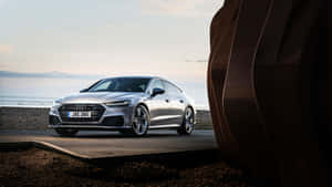 Stunning Audi S7 In Motion On A Picturesque Road Wallpaper