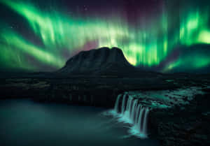 Stunning Aurora Borealis Dancing Across The Night Sky Wallpaper