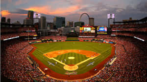 Stunning Baseball Stadium Under Dazzling Floodlights Wallpaper