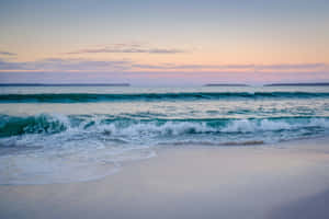 Stunning Beach Waves Crashing On Shoreline Wallpaper