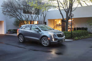 Stunning Black Cadillac Xt5 On The Road Wallpaper