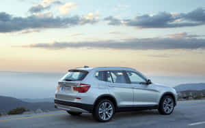 Stunning Bmw X3 Cruising On The Open Road Wallpaper