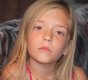 Stunning Brown Eyed Girl With A Whimsical Smile Wallpaper