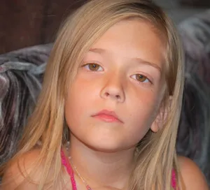 Stunning Brown Eyed Girl With A Whimsical Smile Wallpaper