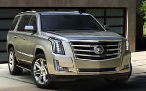 Stunning Cadillac Escalade Suv In Luxurious Setting Wallpaper